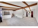 Bright and airy living room with vaulted ceilings, exposed beams and neutral carpet at 3792 S Fenton Way, Denver, CO 80235