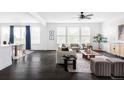 Spacious living room with ample natural light, dark floors, and stylish contemporary furniture at 15977 Red Bud Dr, Parker, CO 80134