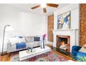 Inviting living room featuring a decorative fireplace, wood floors, comfortable seating, and neutral decor at 2211 W 33Rd Ave, Denver, CO 80211