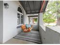 Relaxing porch with a wooden porch swing, striped rug, and gray painted walls at 2211 W 33Rd Ave, Denver, CO 80211