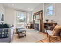 Bright living room showcasing a decorative window, stylish furniture, and beautiful fireplace at 493 S Lincoln St, Denver, CO 80209