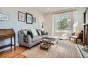 Cozy living room with a comfortable sofa, decorative art, and natural light at 493 S Lincoln St, Denver, CO 80209