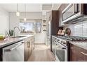 Bright kitchen with stainless steel appliances and a large window providing plenty of natural light at 2321 Eliot St, Denver, CO 80211