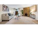 Inviting living room with stone fireplace, modern furnishings, and sliding glass doors at 201 Wright St # 106, Lakewood, CO 80228
