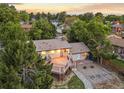 Aerial view showcases a spacious deck, mature trees, and well-maintained backyard at 13055 E Dakota Ave, Aurora, CO 80012