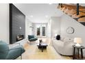 Bright living room with hardwood floors, modern fireplace, and stylish furnishings at 2179 S Bannock St, Denver, CO 80223