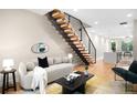 Inviting living room with staircase, wood floors, and contemporary décor at 2179 S Bannock St, Denver, CO 80223