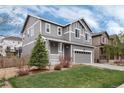 Gray two-story home featuring a welcoming front porch and well-maintained landscaping at 7844 Grady Cir, Castle Rock, CO 80108