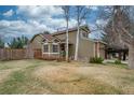 A well-maintained lawn and mature trees complement the charming exterior of this inviting home at 16309 Hedgeway Dr, Parker, CO 80134