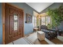 Inviting front foyer with patterned chair, front door, and plenty of natural light at 16309 Hedgeway Dr, Parker, CO 80134