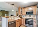 Well-maintained kitchen area with stainless steel appliances and light wood cabinets at 16309 Hedgeway Dr, Parker, CO 80134