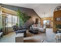 Open living room area offering lots of natural light, neutral decor, and vaulted ceilings at 16309 Hedgeway Dr, Parker, CO 80134