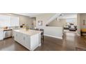 Bright and airy kitchen featuring a large center island, white cabinets, and modern appliances at 12845 Park Creek Way Way, Firestone, CO 80504