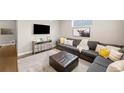 Comfortable living room featuring a sectional sofa, area rug, and an entertainment center at 12845 Park Creek Way Way, Firestone, CO 80504