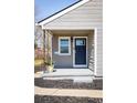 Charming home entryway with a navy blue door, pot with flowers and neutral siding at 190 S Canosa Ct, Denver, CO 80219