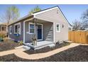 Charming gray home featuring a blue front door, manicured flower beds, and inviting curb appeal at 190 S Canosa Ct, Denver, CO 80219