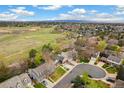 Stunning aerial view showcasing the neighborhood and surrounding green spaces, with mountains visible in the distance at 6340 E Costilla Pl, Centennial, CO 80112
