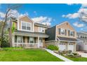Charming two-story home featuring a welcoming front porch, manicured lawn, and a two-car garage at 6340 E Costilla Pl, Centennial, CO 80112