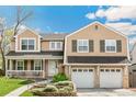Beautifully landscaped two-story home with a well-kept lawn and a two-car garage, offering curb appeal at 6340 E Costilla Pl, Centennial, CO 80112