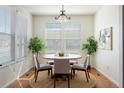 Cozy dining room featuring a wood floor, plants, and a light fixture at 19834 W 56Th Pl, Golden, CO 80403