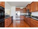 Kitchen with wood cabinets, stainless steel appliances, and granite countertops at 19834 W 56Th Pl, Golden, CO 80403