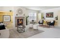 Bright living room features a fireplace, neutral color palette and large windows at 19834 W 56Th Pl, Golden, CO 80403