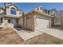 Close up of a two-story house with brick facade and a two-car garage at 6651 Yale Dr, Highlands Ranch, CO 80130
