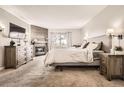 Cozy main bedroom with a fireplace, wood accent wall, and large windows with a view at 6651 Yale Dr, Highlands Ranch, CO 80130