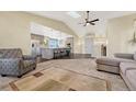 Open concept living room with a vaulted ceiling, a skylight, modern furnishings, and seamless flow to the kitchen at 2460 Eileen Way, Parker, CO 80138