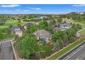Aerial view of a home surrounded by mature trees and lush greenery in a beautiful golf course community at 1999 Champions Cir, Castle Rock, CO 80104