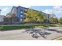 Modern apartment building with landscaping seen from the street on a sunny day at 487 Interlocken Blvd # 307, Broomfield, CO 80021
