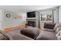 Comfortable living room with a gray fireplace and a large window providing natural light and neighborhood views at 2582 Beech Ct, Golden, CO 80401