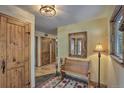 Inviting foyer with wooden bench, mirror, decorative lighting and wood accents at 609 Brook Dr, Idaho Springs, CO 80452