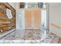 Grand foyer features marble floors, statement walls, and an elegant double door entryway at 23655 Currant Dr, Golden, CO 80401