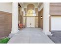 Charming entryway with double doors, sidelights, grand columns, and a cozy bench at 23655 Currant Dr, Golden, CO 80401