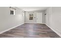 Bright and airy living room with grey walls and wood-look floors at 1330 Ammons St, Lakewood, CO 80214