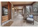 Inviting covered front porch with stone pillars and a welcoming entrance at 8707 Windhaven Dr, Parker, CO 80134