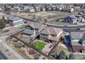 A birds-eye view reveals a home with a fenced backyard, complemented by a green lawn and bordered by trees, with neighborhood at 10375 Knollside Dr, Parker, CO 80134