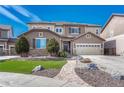 A stately two-story residence featuring a well-kept lawn, complemented by stone accents and a side-entry two-car garage at 10375 Knollside Dr, Parker, CO 80134