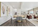 Open-concept dining area with modern chairs and hardwood floors, seamlessly connected to the kitchen and living spaces at 2153 Flower Blossom Ave, Brighton, CO 80601