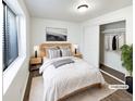Serene bedroom with soft lighting, neutral decor, closet, and a large window overlooking a green space at 344 W 116Th Ave, Northglenn, CO 80234