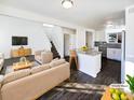 Bright, open-concept living room featuring modern furnishings, hardwood floors, and an island with barstool seating at 344 W 116Th Ave, Northglenn, CO 80234