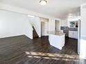 Bright, open-concept living room featuring hardwood floors and an island with barstool seating at 344 W 116Th Ave, Northglenn, CO 80234