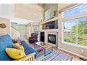 Inviting living room boasts high ceilings, a fireplace, and lots of natural light from large windows at 930 Button Rock Dr # 28, Longmont, CO 80504