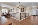 Elegant foyer featuring hardwood floors, staircase with rod iron railing and an adjacent dining room at 6450 S Riverwood Ct, Aurora, CO 80016