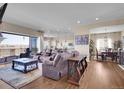 Spacious living room flows into the kitchen and dining area, perfect for entertaining guests at 6450 S Riverwood Ct, Aurora, CO 80016