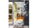 Inviting entryway featuring hardwood floors, a contemporary light fixture, and an open doorway at 2525 S Meade St, Denver, CO 80219