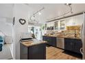 Modern kitchen featuring stainless steel appliances, granite counters, tile backsplash and hardwood floors at 1223 Race St # 605, Denver, CO 80206