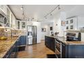 Open kitchen features stainless steel appliances, granite counters, and two-tone cabinetry at 1223 Race St # 605, Denver, CO 80206