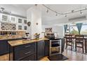 Kitchen features granite countertops, stainless steel appliances, two-tone cabinets and an adjacent dining area at 1223 Race St # 605, Denver, CO 80206